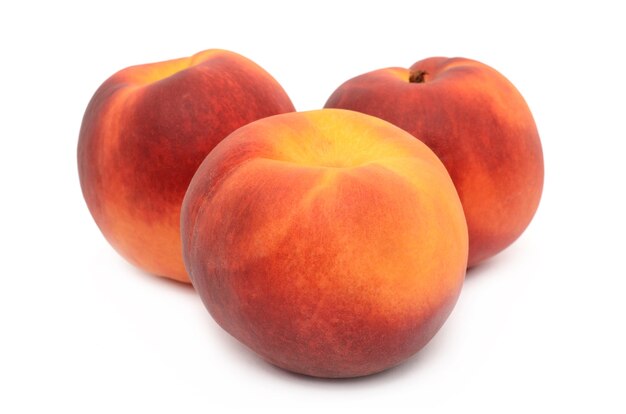 Peaches on a white surface