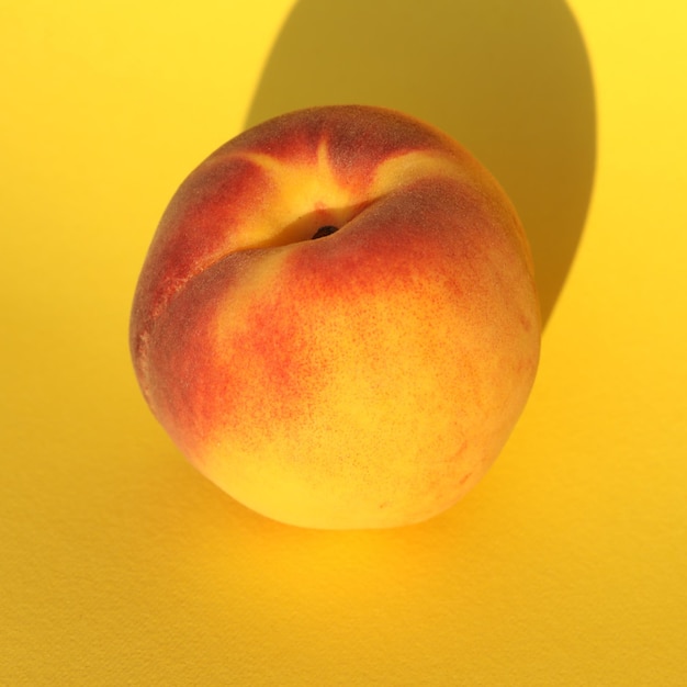 peaches on the yellow background with copy space