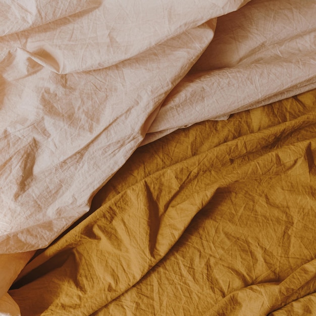 Peachy beige and ginger bed linen cloth Crumpled blanket textile pattern