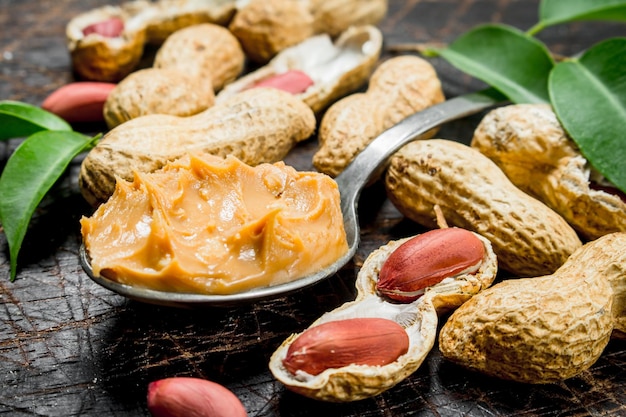 Peanut butter in a spoon with leaves