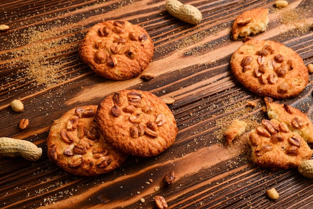 Peanut cookies on wooden table with sugar