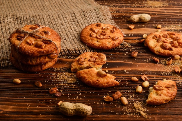 Peanut cookies on wooden table with sugar