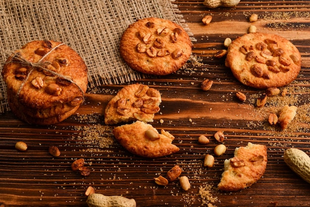 Peanut cookies on wooden table with sugar