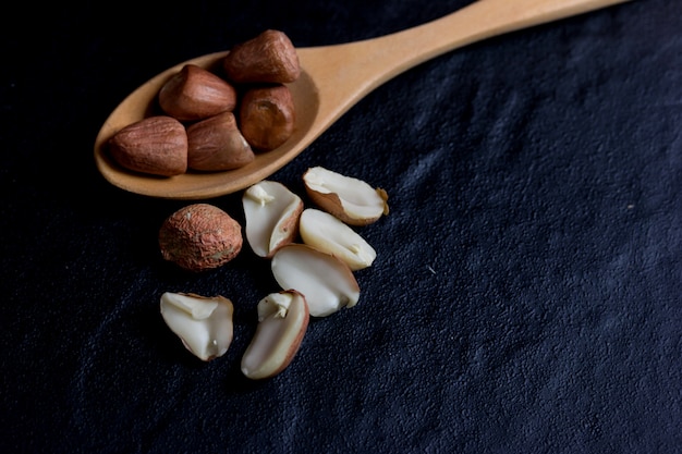 Peanut on Cup made of wood and spoon 