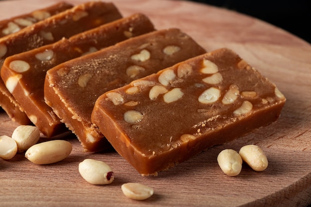 Peanut home toffee on a wooden board. slices of eastern sweets with nuts.