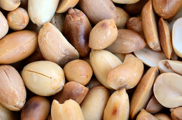 Peanut. A lot of small yellow nuts without peel. Background texture