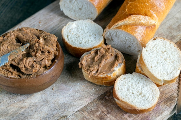 Peanut paste with pieces of peanuts and white baguette peanut butter breakfast with pieces of nuts and wheat baguette