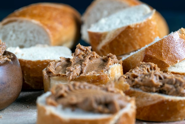 Peanut paste with pieces of peanuts and white baguette