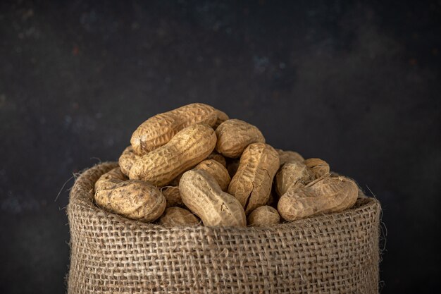 Peanut in sack bag on black table