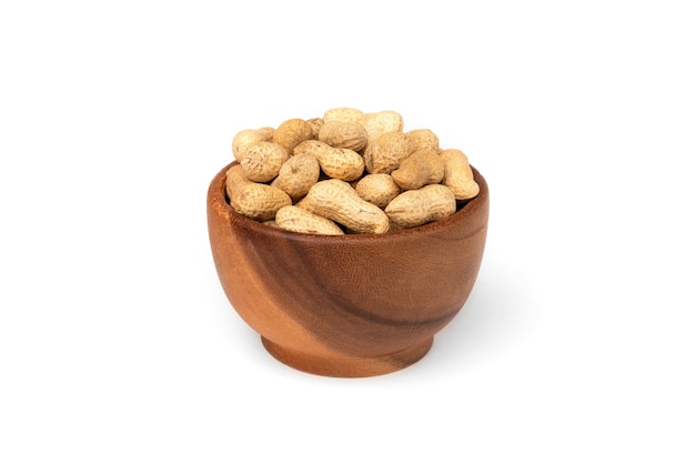 Peanut in the shell in wooden bowl isolated.