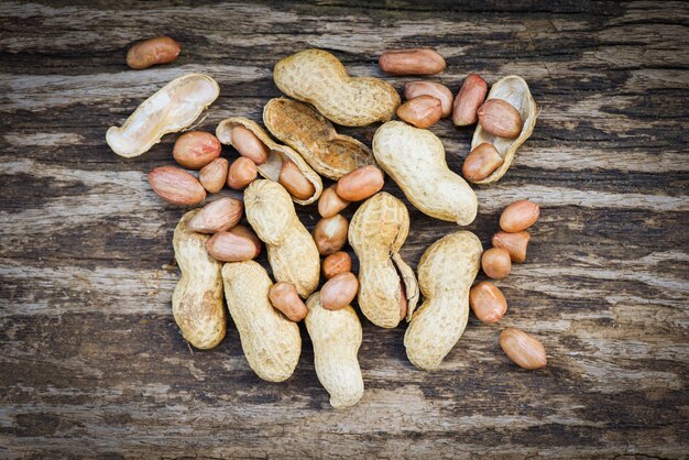 Peanut in shells for food or snack / Roasted peanuts on rustic wood background