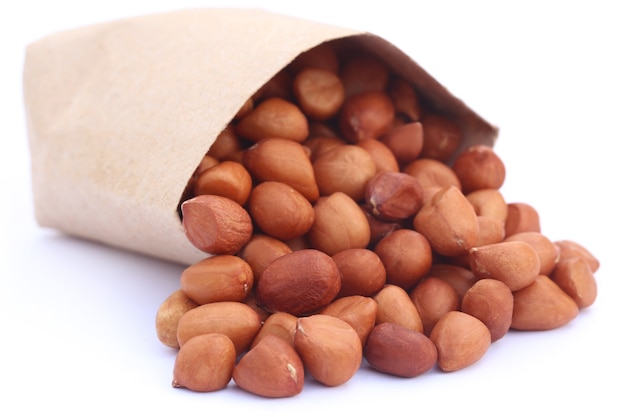 Peanut with a paper pack over white background