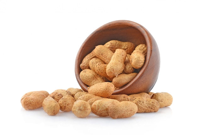 Peanut in wooden cups isolated on white background.