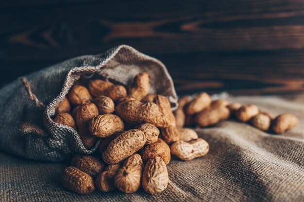 Peanuts in a bag on a woody background