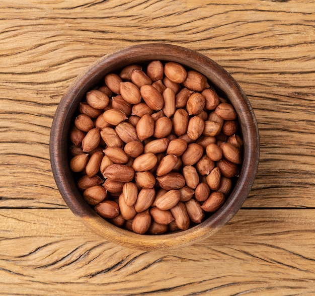 Peanuts in a bowl over wooden table