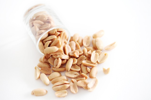 Peanuts in the glass on white background