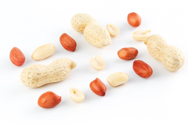 Peanuts isolated on white background. Peeled Peel and Scarlup.