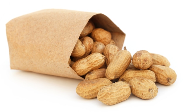 Peanuts in a packet over white background