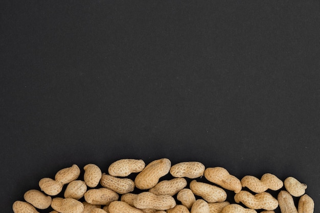 Peanuts in shell on black background