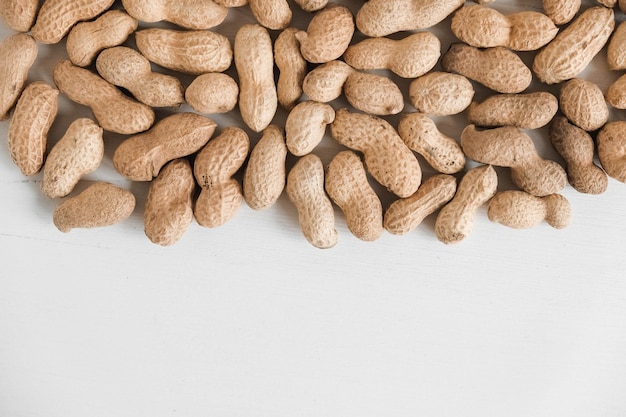 Peanuts in shell on a white background. Top view. Copy, empty space for text