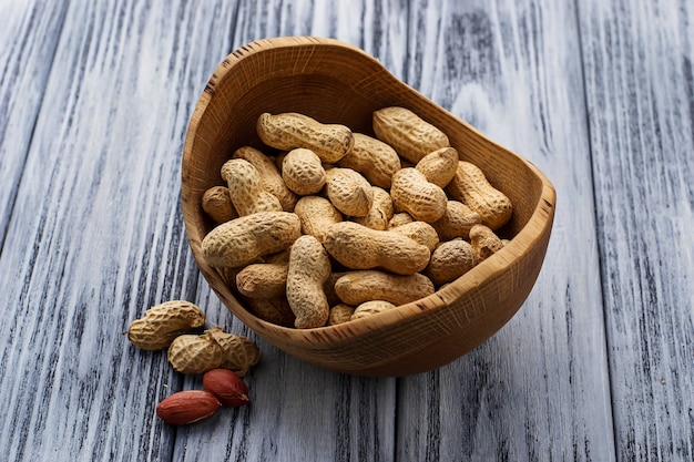 Peanuts in shell on wooden background