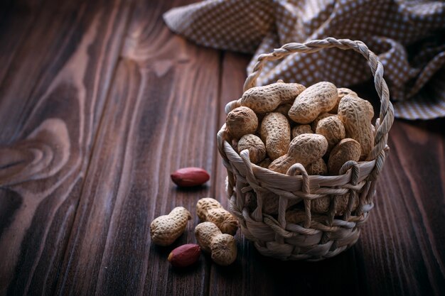 Peanuts in shell on wooden background