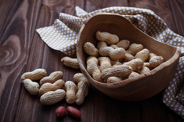 peanuts in shell on wooden background