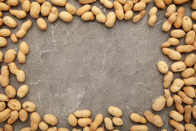 Peanuts in shells on grey table