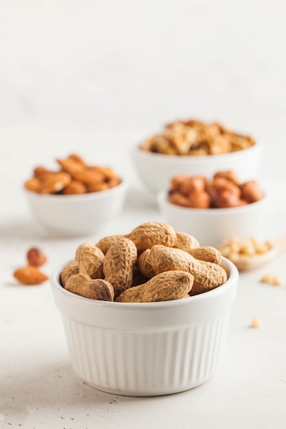 Peanuts in their shells. Assorted nuts almonds, hazelnuts, walnuts. Healthy snacks. Copy space.