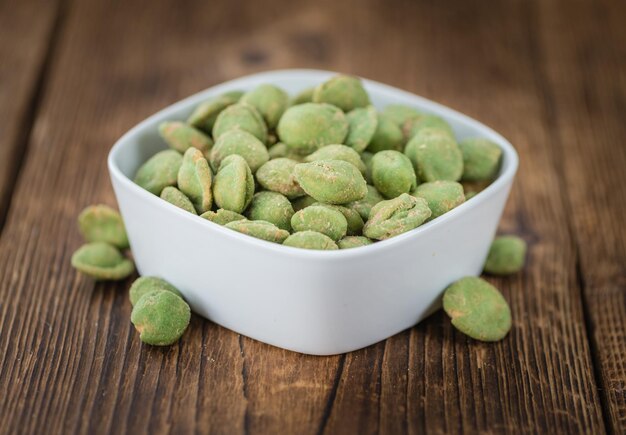 Peanuts with Wasabi flavor on vintage wooden background