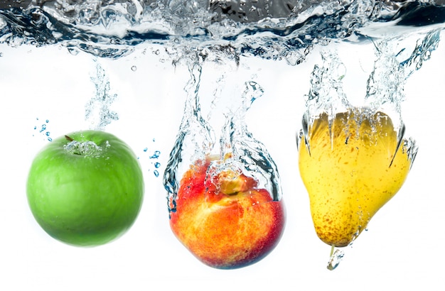 pear and apple falling in water