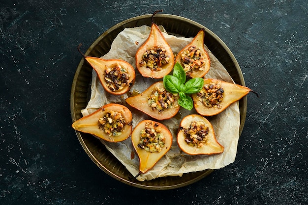 Pear baked with blue cheese nuts and honey on a metal tray top view free copy space