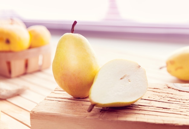 Pear cut in half on a wooden surface