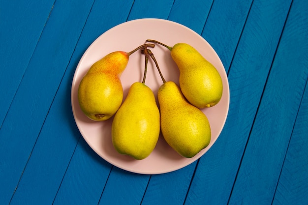 Pear decoration stock images. Yellow pear on blue  Pear home decor. Yellow decorative pear