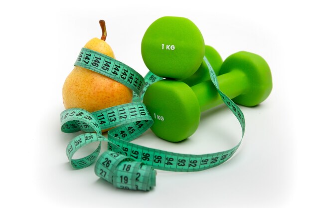 Pear and green dumbbells with a Measuring tape on white