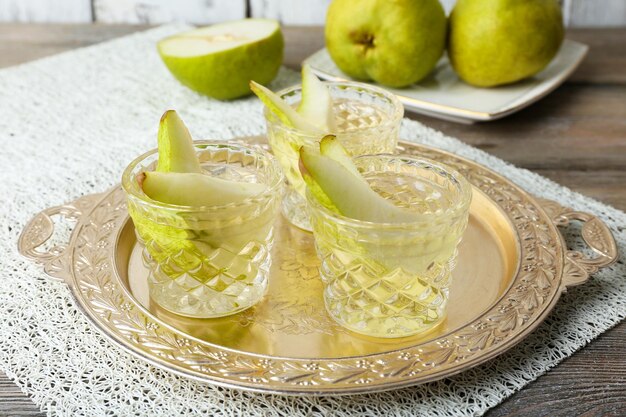 Pear juice with fresh fruits on table close up