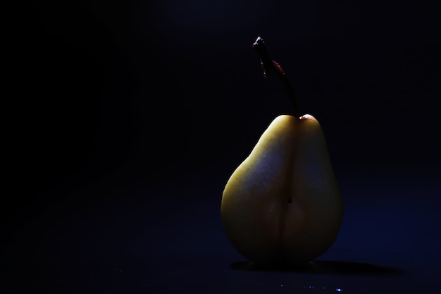 Pear slices on a black background.pears in a plate and slices of pears top view.