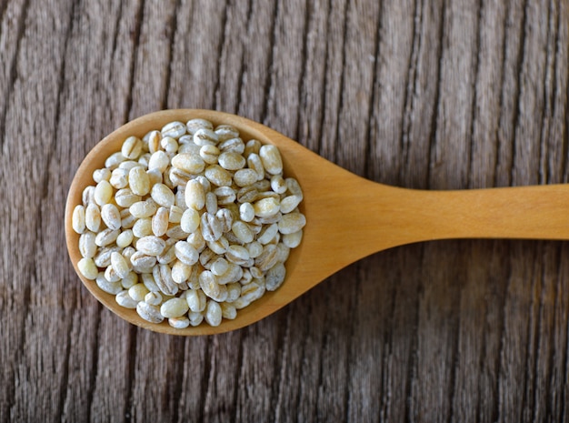 Pearl barley in swood spoon