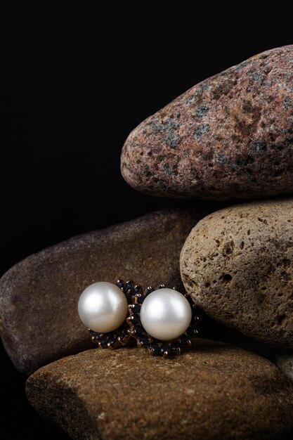 pearl earrings on stones jewelry shooting