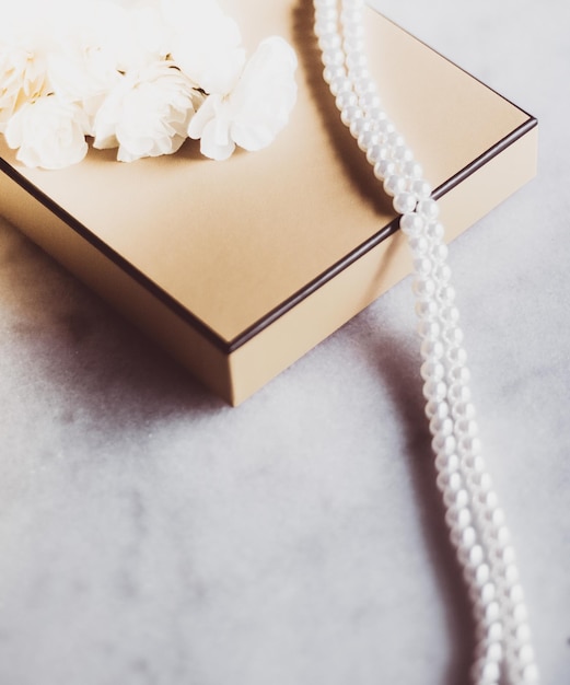 Pearl jewellery in a golden gift box