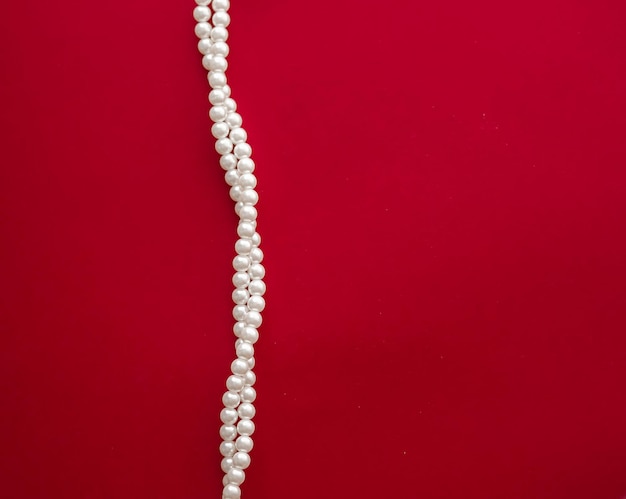 Photo pearl jewellery necklace on red background