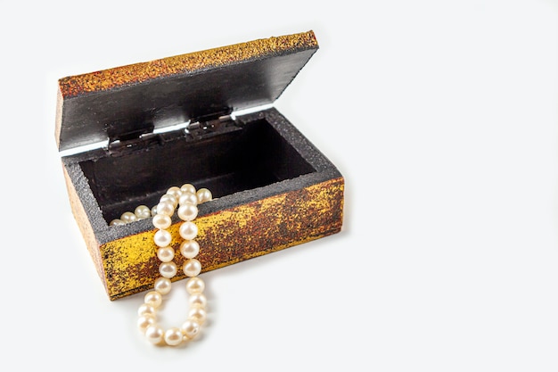 Pearl necklace, beads in antique metallic vintage casket