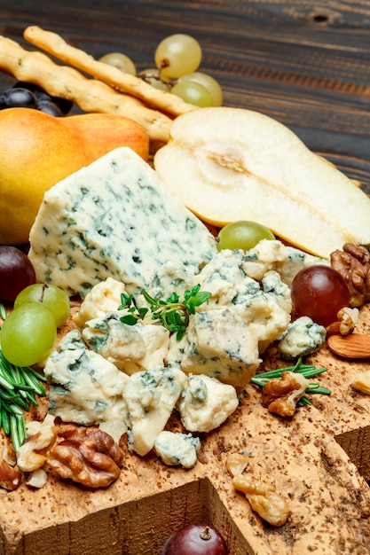 Pears and cheese on wooden cutting board