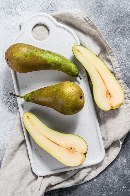 Pears on Kraft paper. Seasonal ripe pears. Gray background. Top view. Space for text.