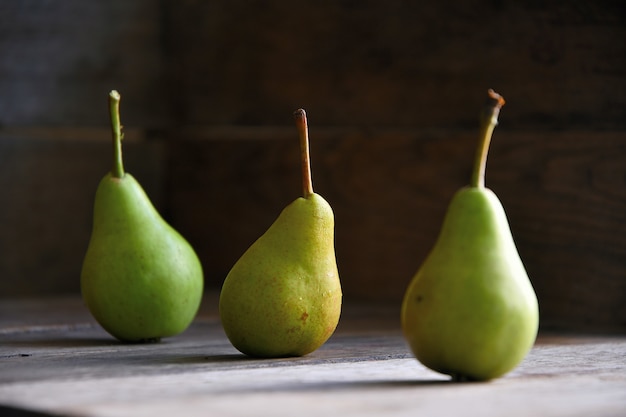 Pears lie on old oak boards.