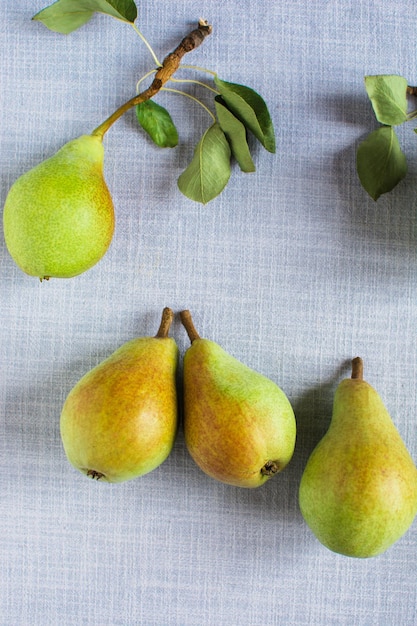 Pears in a plate and slices of pears top view wooden background with pears