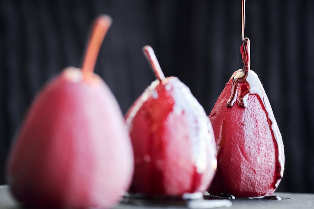 Pears in red wine isolated on black