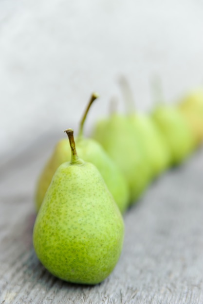 Pears in a row on a wooden surface