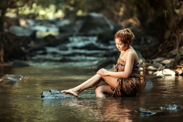 Peasant women bathing after completion of daily rice farming work