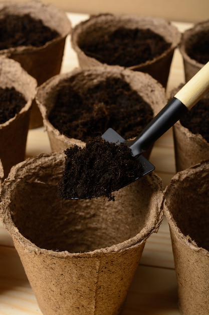 Peat pots with soil and shovel